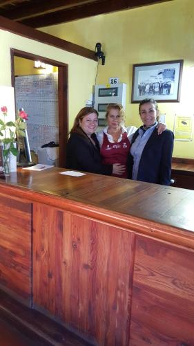 a group of people standing behind a wooden counter at Fonda Central in Adeje