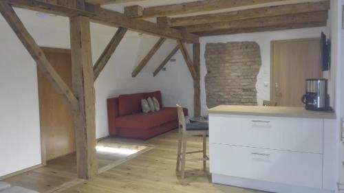 a kitchen and living room with a red couch at Gästehaus Hosp in Reutte