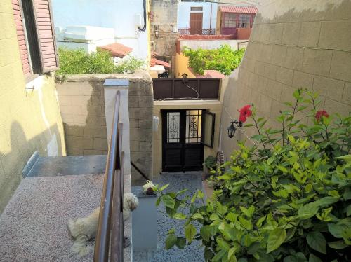 a view of a balcony with a dog laying on the stairs at Stathis in Rhodes Town