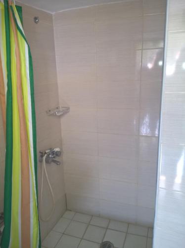 a bathroom with a shower with a shower curtain at Stathis in Rhodes Town