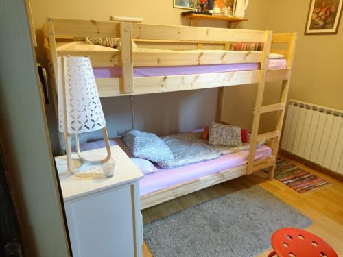 a bunk bed in a room with a lamp at Apartments Kamenecki in Krapina