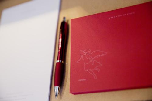 a red book with a pen next to it at Hotel Angela in Lech am Arlberg