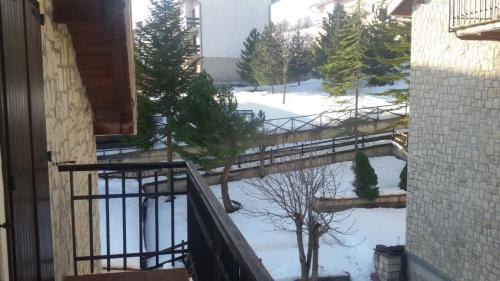 a balcony with snow on the ground and trees at Appartamento Lucia in Pescocostanzo