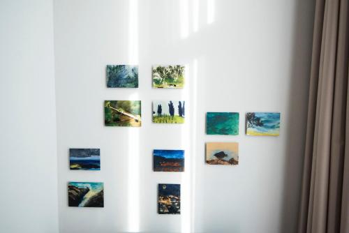 a group of photographs on a white wall at Art-Hotel Robert Mayer in Frankfurt/Main