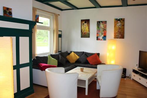 a living room with a couch and a table and chairs at Ferienwohnung Villa Parkblick in Oberhof