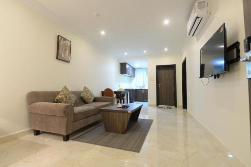 a living room with a couch and a coffee table at Top View - شقق المنظر in Al Hofuf