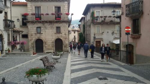 a group of people walking down a street at Appartamento Lucia in Pescocostanzo