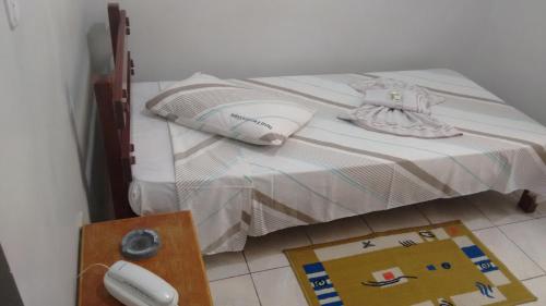 a bed and a desk in a room at Hotel Ferreira Viana in Rio de Janeiro