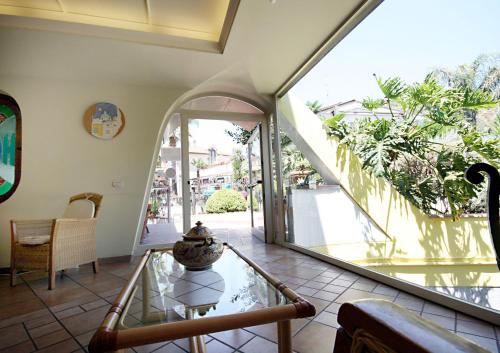 a room with a glass table and a large window at Hotel Il Ceppo in Agropoli