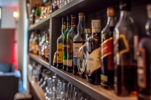 a row of bottles of alcohol on the shelves of a bar at Parkhotel Ahrbergen in Giesen