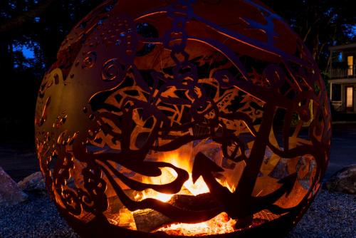 a pumpkin with a fire inside of it at Treehouse Lodge in Woods Hole
