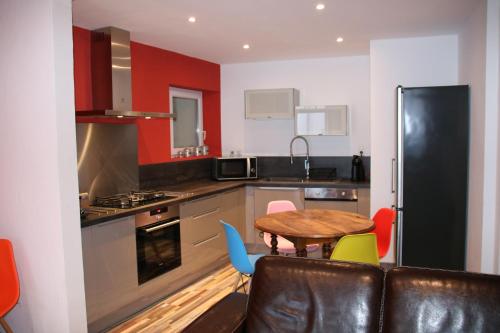 a kitchen with a table and colorful chairs in it at La carpe diem in Bédoin