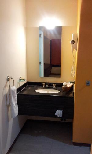 a bathroom with a sink and a mirror at Hotel Real del Sol in Cuernavaca