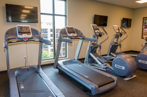a gym with three tread machines in a room at Edge Hotel Clearwater Beach in Clearwater Beach