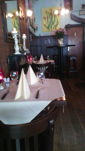 a dining room with a table with wine glasses at Schuttershof Heerlen - Adults Only in Heerlen