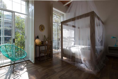 Ένα ή περισσότερα κρεβάτια σε δωμάτιο στο El Patio 77 B&B