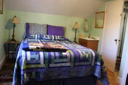 a bedroom with a bed with a quilt on it at Sunshine House Bed and Breakfast in Seward