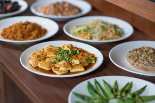 a table with white plates of food on it at sunlight mound in Yuanshan
