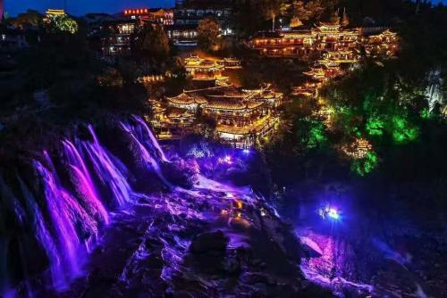 a view of a waterfall at night with lights at 372 Jingjing Home in Yongshun