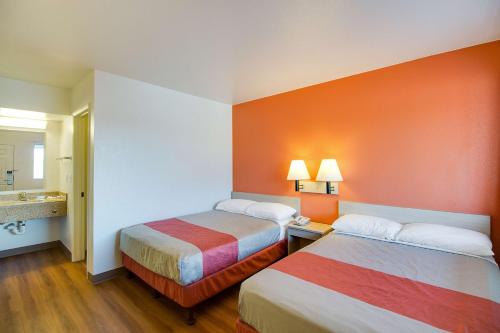 a hotel room with two beds and a bathroom at Motel 6-Phoenix, AZ - East in Phoenix