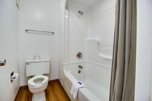 a white bathroom with a toilet and a shower at Motel 6-Phoenix, AZ - East in Phoenix