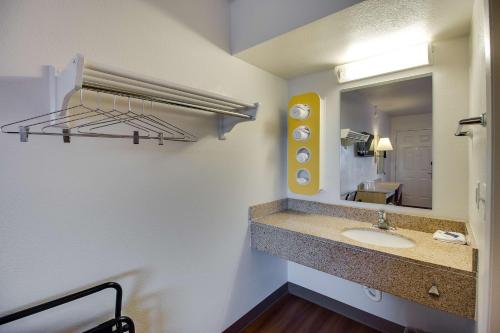 a bathroom with a sink and a mirror at Motel 6-Phoenix, AZ - East in Phoenix