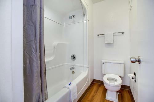 a white bathroom with a toilet and a shower at Motel 6-Phoenix, AZ - East in Phoenix
