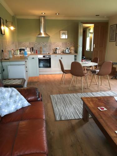 a living room with a couch and a table at One Slade Gardens in The Mumbles