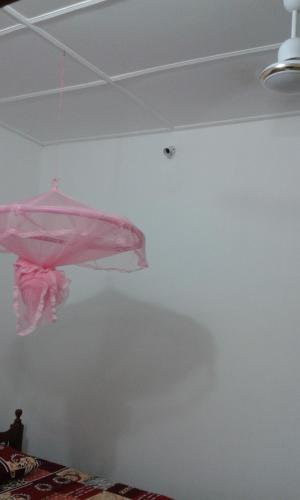 a room with a pink item hanging from the ceiling at Sea Zone Hotel Nilaveli in Nilaveli
