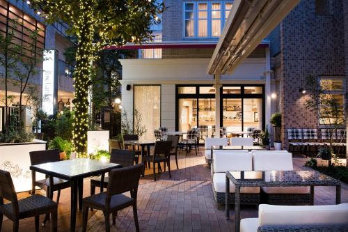 a patio of a restaurant with tables and chairs at Hotel Rose Garden Shinjuku in Tokyo