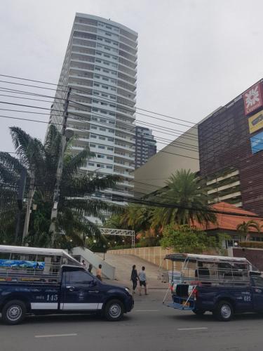 a truck and a bus parked in front of a building at View Talay 6 Pattaya in Pattaya