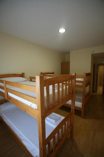 a group of bunk beds in a room at Albergue La Encina in Hospital de Órbigo