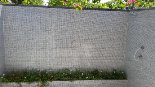 a brick wall with a bunch of flowers on it at Lombok Sunset Hideaway in Lembar