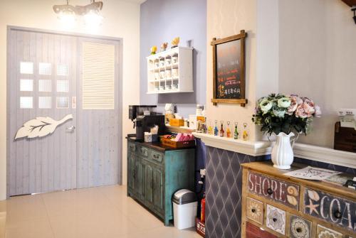 a kitchen with a counter with a flower vase at Sun Giraffe Taitung B&B in Taitung City