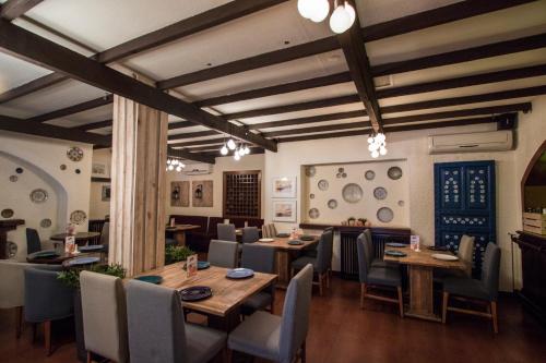 a dining room with wooden tables and chairs at Bonita Inn in Amman