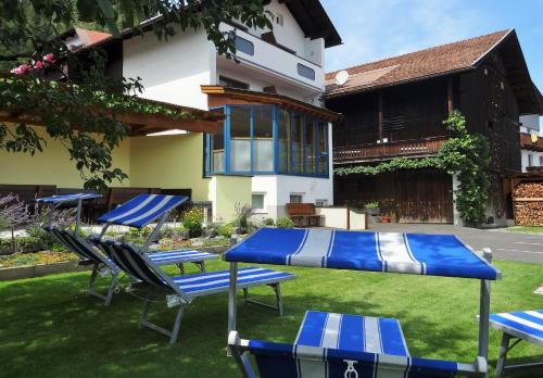 a group of chairs and tables in a yard at Pension Schöpf in Arzl im Pitztal