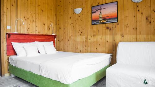 a bedroom with two beds in a wooden wall at Vila Far in Sfântu Gheorghe