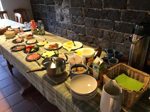 a table with food and dishes on it at Bjärkas Golf & Country Club in Nivelax