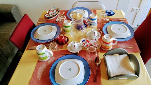 a table with plates and dishes on top of it at B&B Dafne Marsala Centro in Marsala