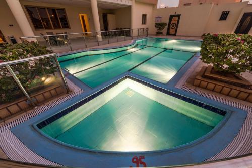 an overhead view of a swimming pool at night at Boudl Al Fakhria in Unayzah