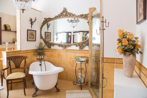 a bathroom with a tub and a sink and a mirror at B&B Nilo in Naples