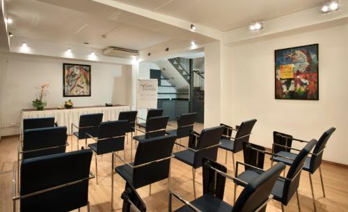 a room with rows of chairs in a gallery at Hotel Gamma in Milan