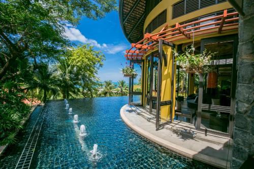 a resort with a swimming pool next to a building at New Star Beach Resort in Chaweng Noi Beach