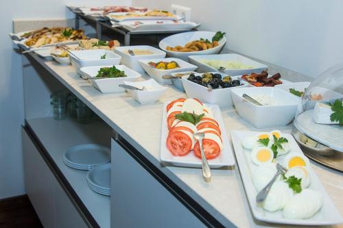 a buffet with plates of food on a table at Hotel Goldenes Rad in Ulm