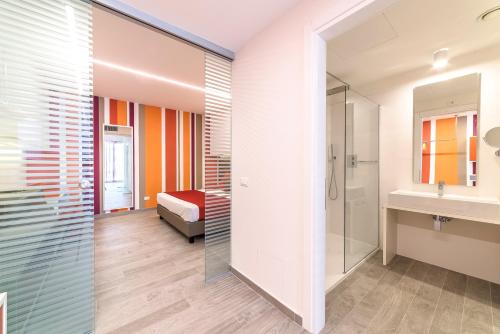a bathroom with a shower and a sink at Hotel Tenda Rossa in Marina di Carrara