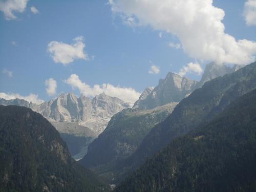 a mountain valley with a lake in the middle at Hotel Stüa Granda in Soglio