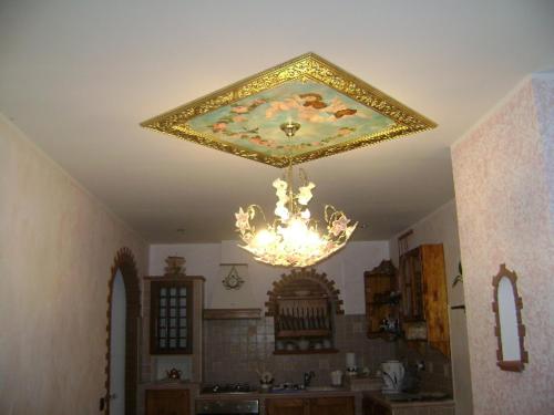 a chandelier hanging from a ceiling in a kitchen at B&B Myosotis in Introdacqua