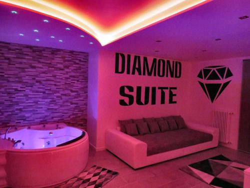 a room with a tub and a sign that reads diamond suite at Diamond Suite Verona in Verona