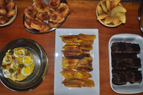 a table topped with plates of food with eggs and bread at Villa Cayana in Barra Grande