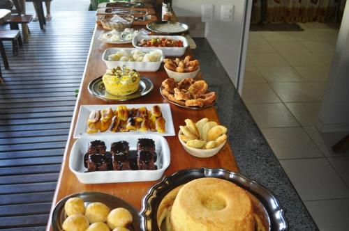 a buffet line with different types of desserts and pastries at Villa Cayana in Barra Grande